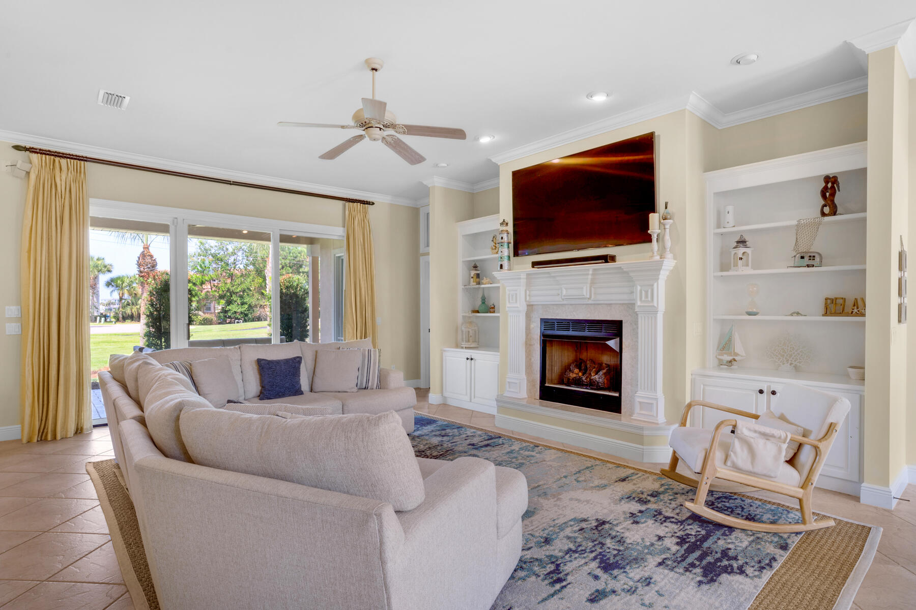 116 Tranquility Lane Destin, FL 32541 - Photo 2 of 27 a living room with furniture a flat screen tv and a fireplace