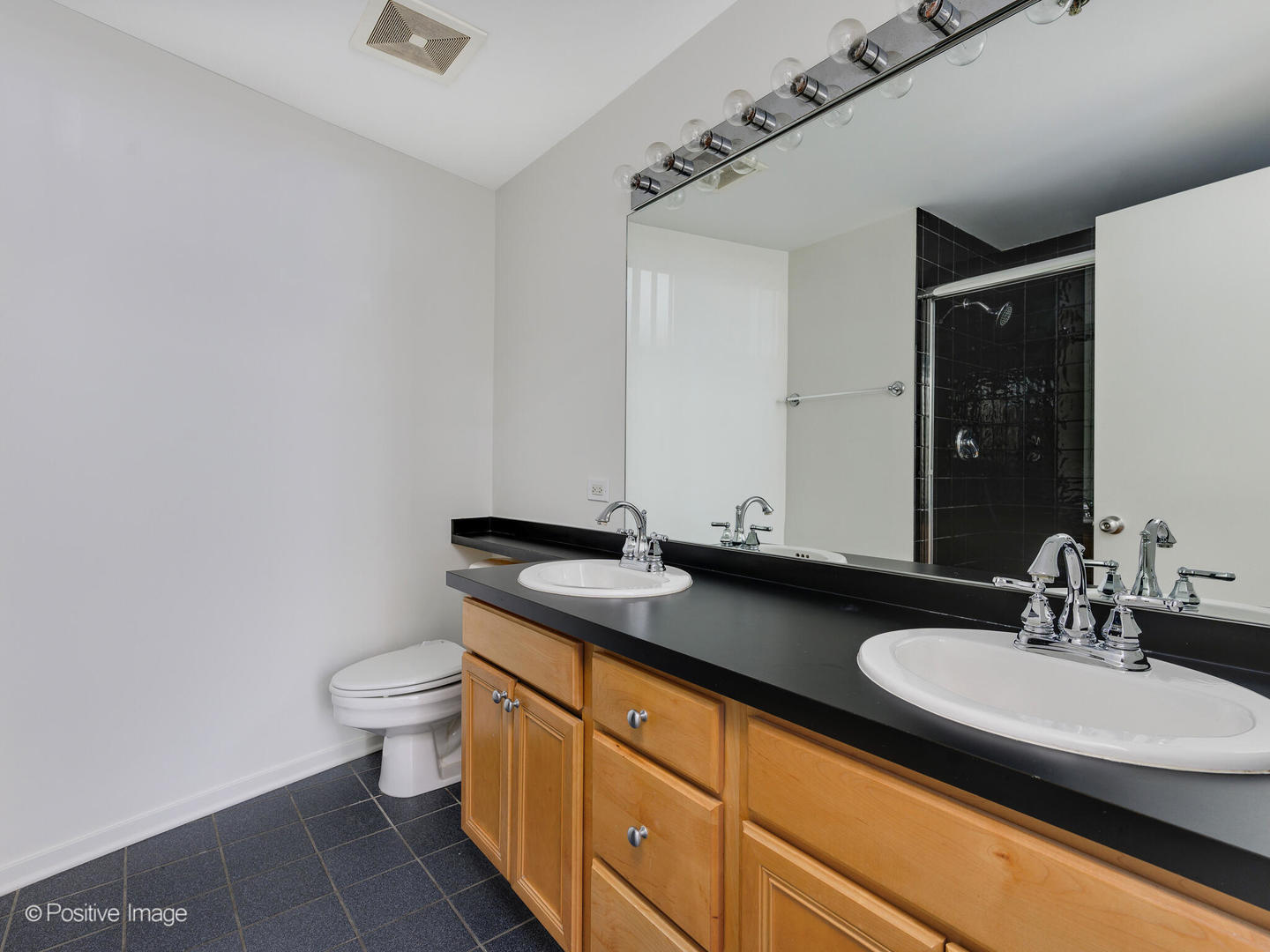 500 South Clinton Street, Unit 110 Chicago, IL 60607 - Photo 10 of 16 a bathroom with a granite countertop sink and a mirror