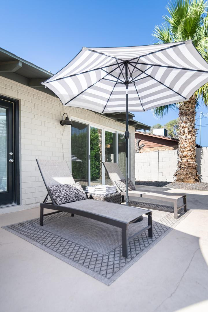 7435 East Granada Road Scottsdale, AZ 85257 - Photo 6 of 28 a outdoor sitting area with couch and umbrella