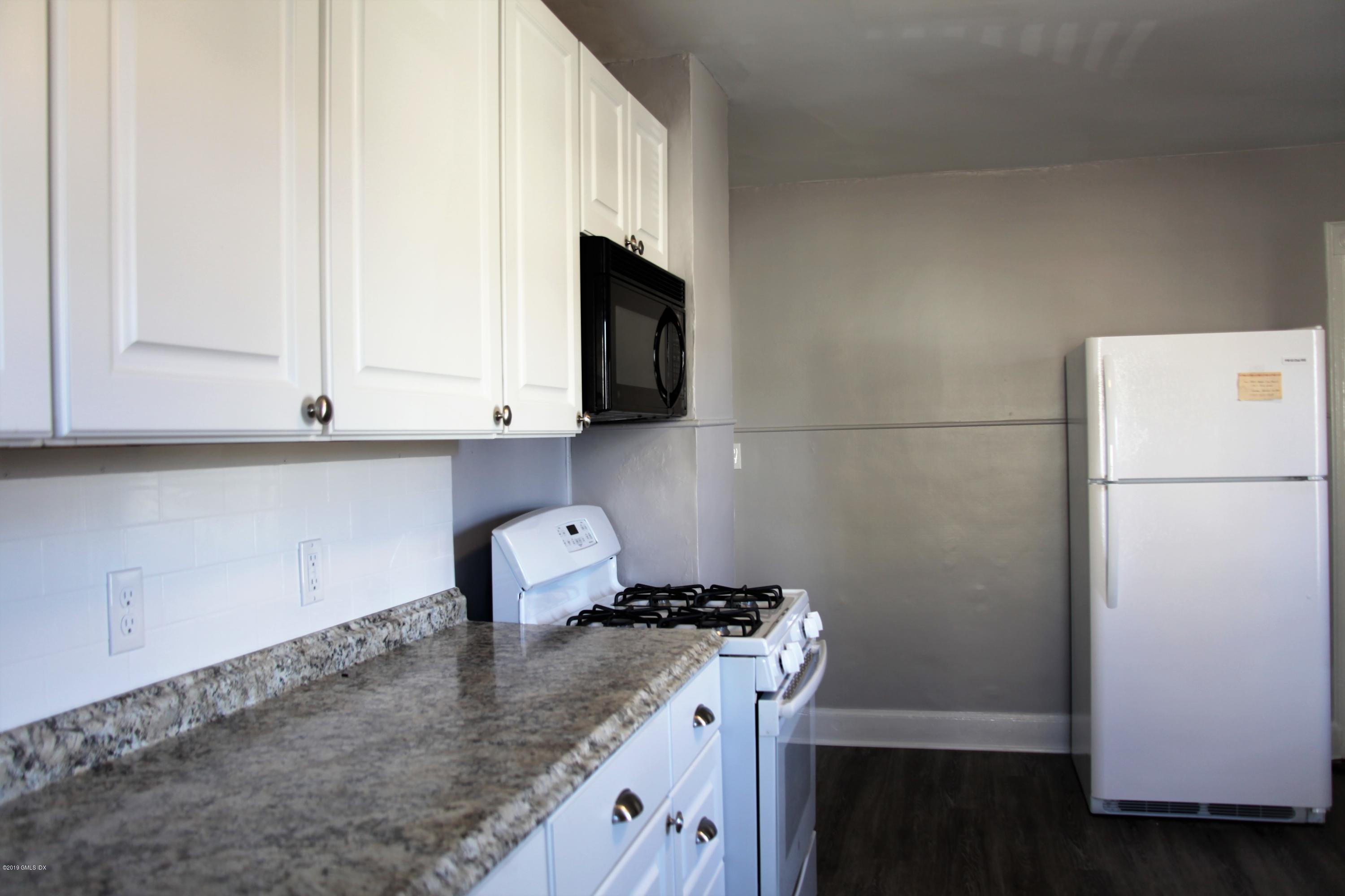 173 Hamilton Avenue Greenwich, CT 06830 - Photo 3 of 12 a kitchen with a sink cabinets and a window
