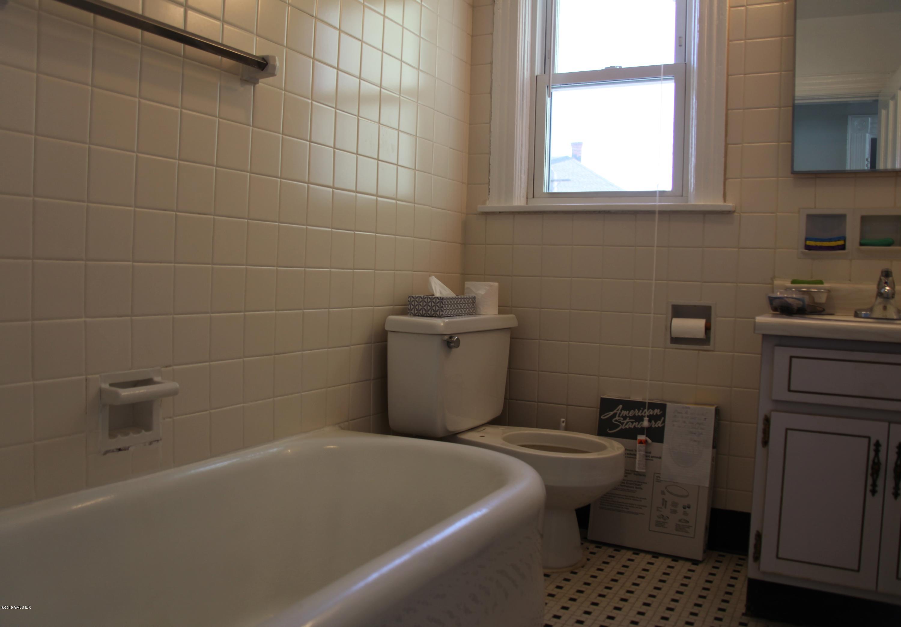 173 Hamilton Avenue Greenwich, CT 06830 - Photo 7 of 12 a bathroom with a sink a toilet and bathtub