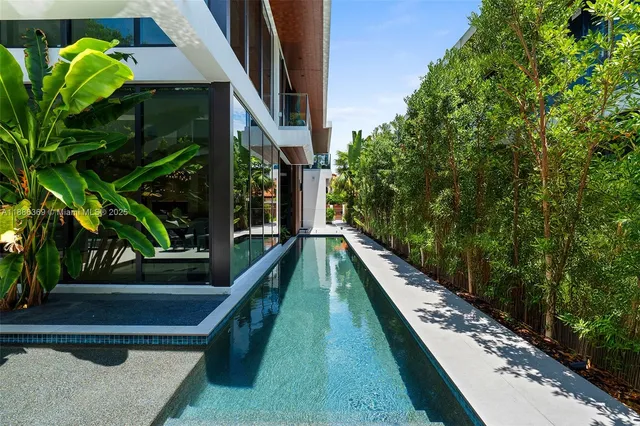 a kitchen with a dining table chairs and white cabinets