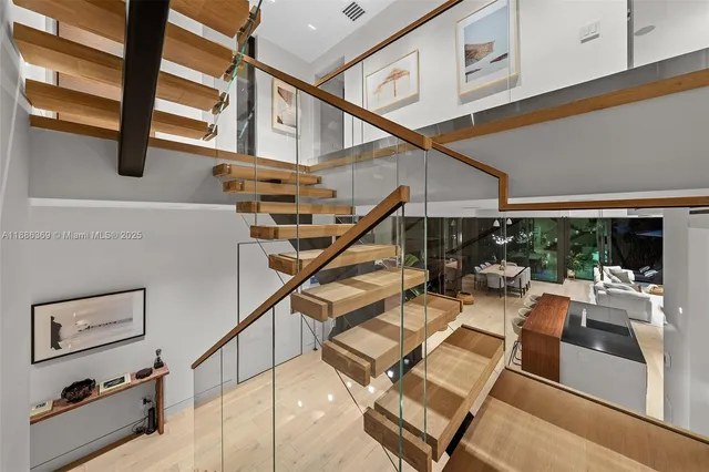 a view of a balcony with chairs and wooden floor