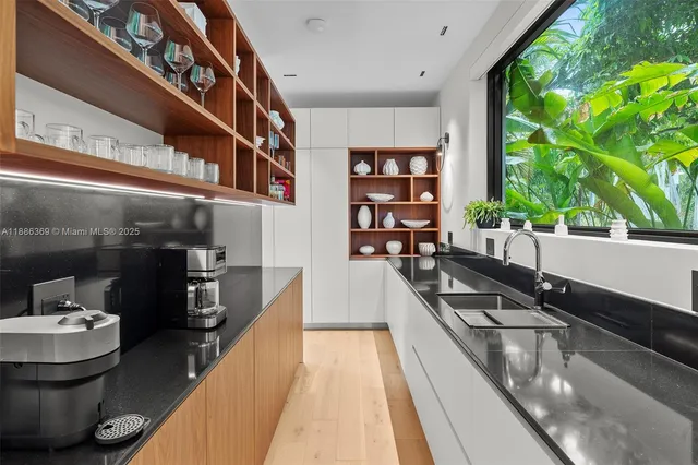 a view of a patio with chairs and potted plants