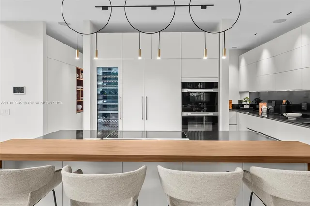 a view of a dining room with furniture wooden floor and chandelier
