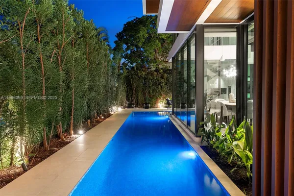 a view of swimming pool with a chair and potted plants