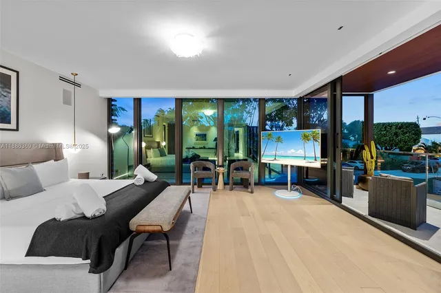 a bedroom with a large bed and a large window