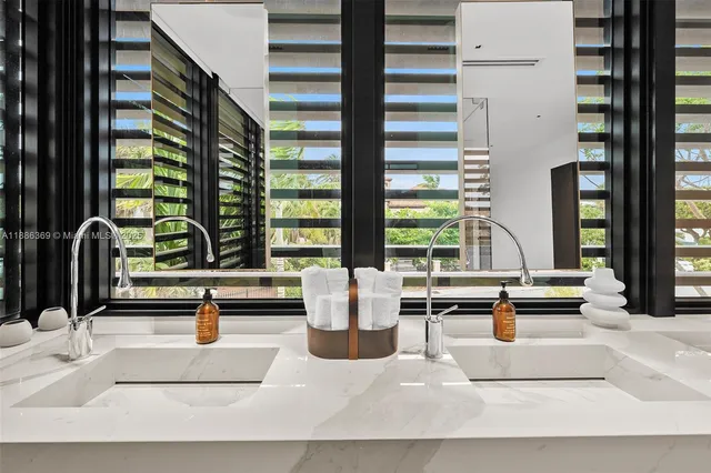 a bed sitting in a bedroom next to a large window