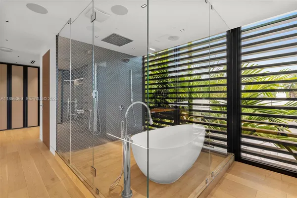 a bedroom with a bed lamp and a window