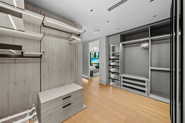 a bedroom with furniture and a large window