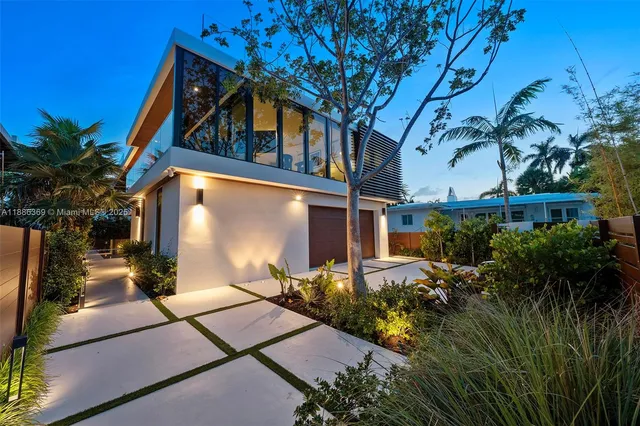 a backyard of a house with table and chairs