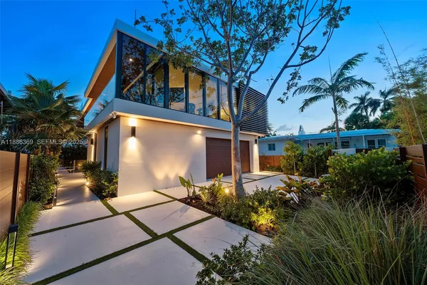 a backyard of a house with table and chairs