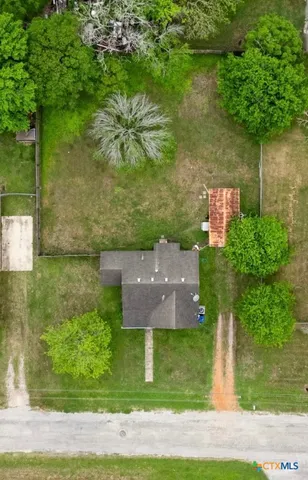 an aerial view of a house with a yard