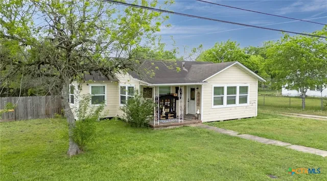 a front view of house with a garden