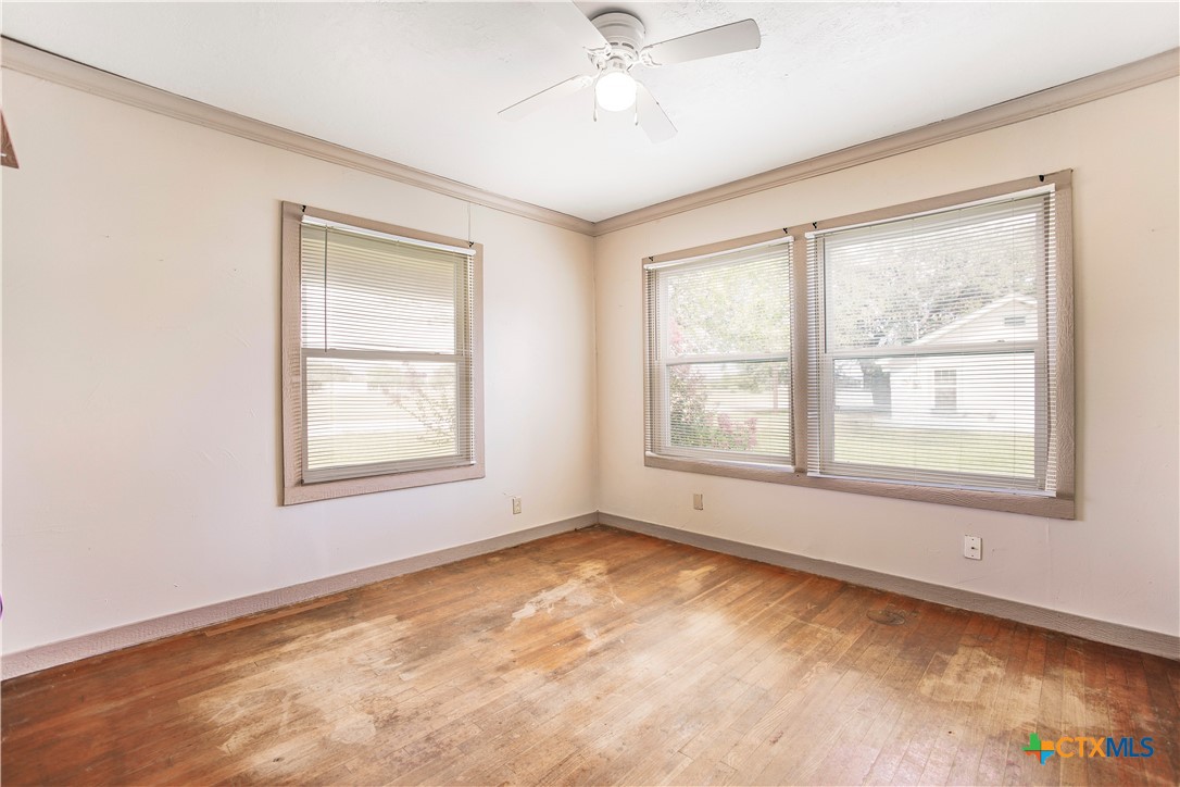 704 Maple Street Yoakum, TX 77995 - Photo 9 of 18 a view of an empty room with a window