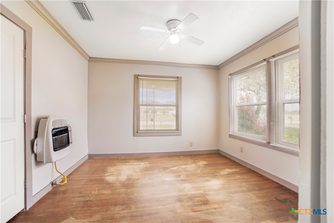 704 Maple Street Yoakum, TX 77995 - Photo 10 of 18 a view of a livingroom with a ceiling fan and window