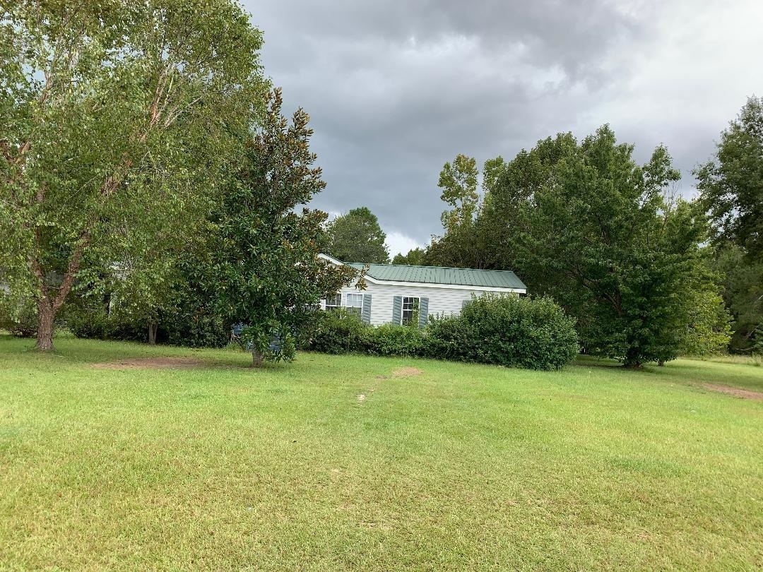4109 Harper Road Metter, GA 30439 - Photo 1 of 1 a view of a large garden with plants and large trees