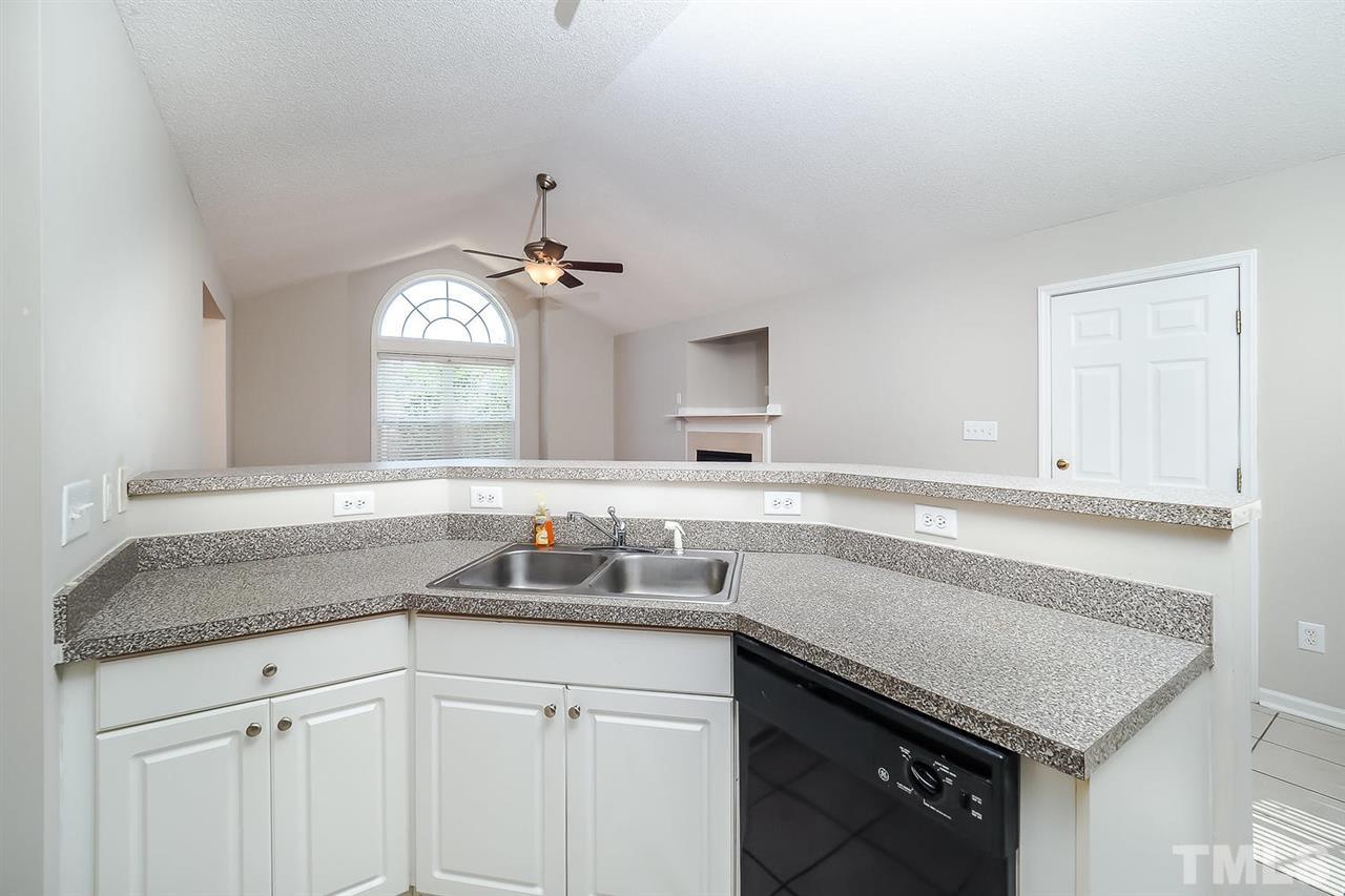 7120 Missionary Ridge Drive Raleigh, NC 27610 - Photo 14 of 25 a kitchen with a sink cabinets and window