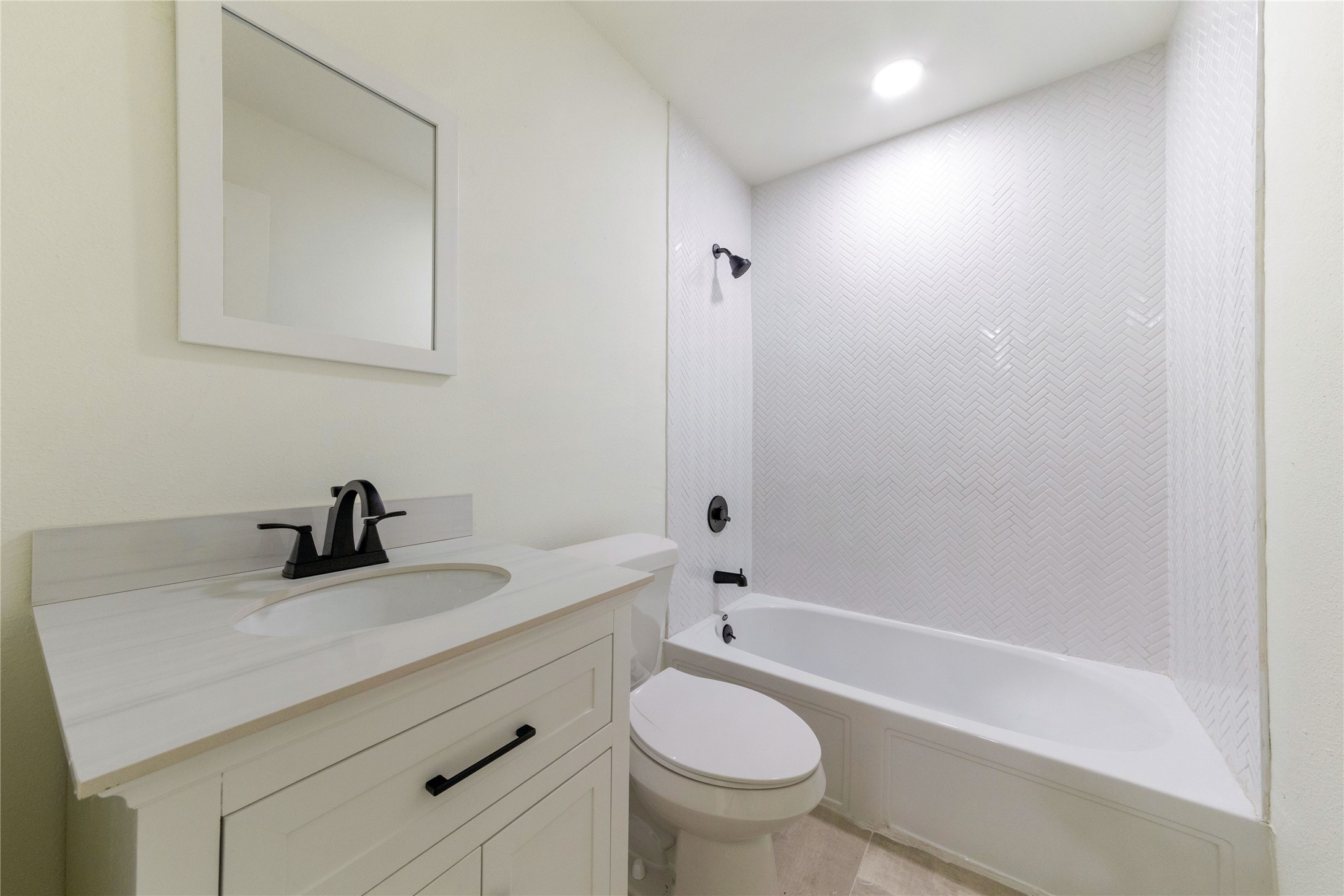 8807 Merion Circle Austin, TX 78754 - Photo 14 of 18 A well-appointed bath features a tiled shower surround and an elegant vanity, perfect for daily routines.