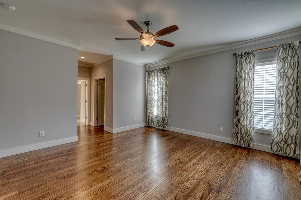 161 Loop Lane Blairsville, GA 30512 - Photo 14 of 67 an empty room with wooden floor fan and windows