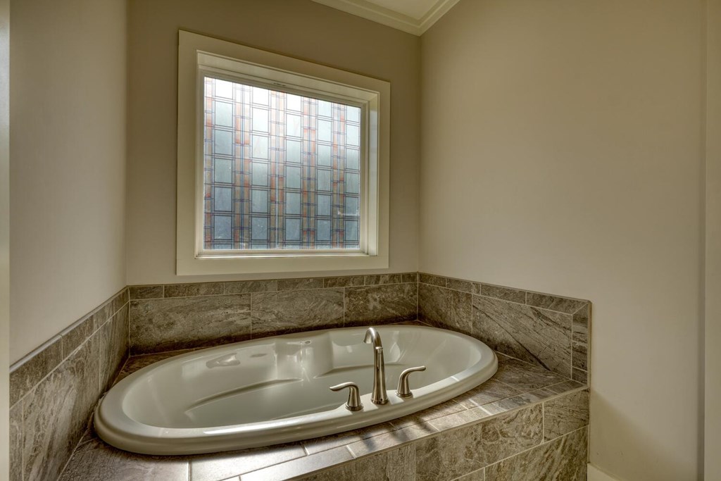 161 Loop Lane Blairsville, GA 30512 - Photo 17 of 67 a bath tub sitting in a bathroom next to a window