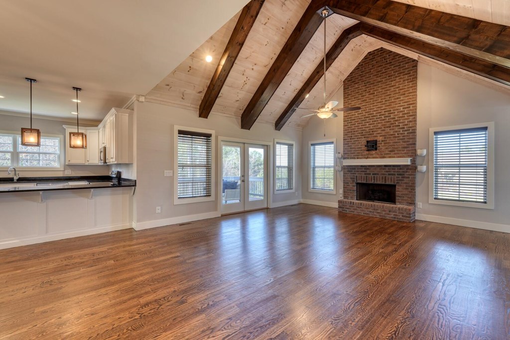 161 Loop Lane Blairsville, GA 30512 - Photo 7 of 67 a view of empty room with wooden floor and fireplace