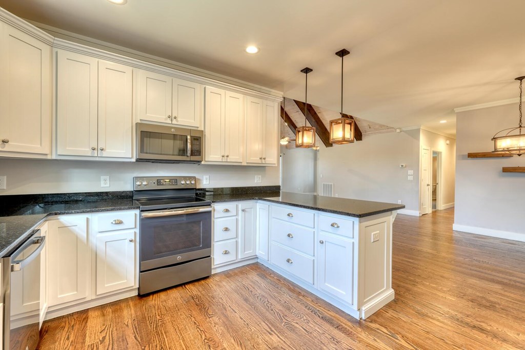 161 Loop Lane Blairsville, GA 30512 - Photo 10 of 67 a kitchen with stainless steel appliances granite countertop a sink a stove and a wooden floors