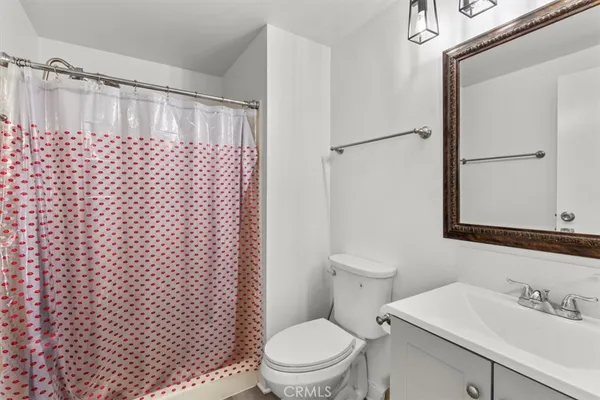 a bed room with a bed window and a mirror