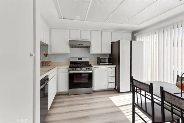 a kitchen with stainless steel appliances a refrigerator stove and microwave