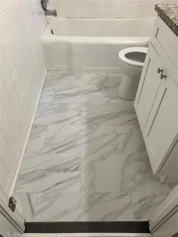 a view of a kitchen with a sink and refrigerator