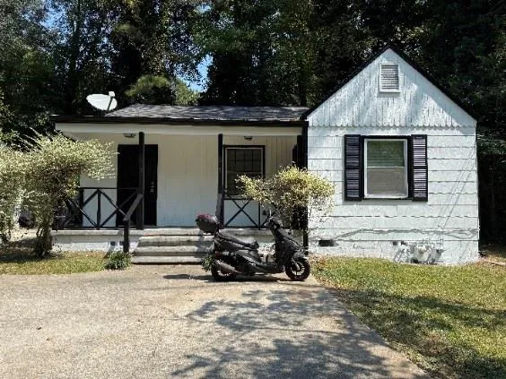 a view of a house with backyard porch and sitting area