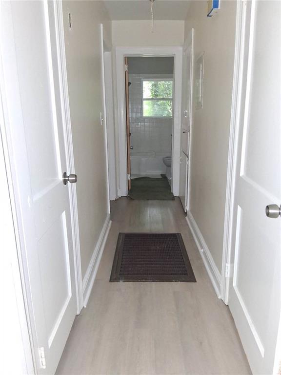 2267 Rugby Terrace Atlanta, GA 30337 - Photo 10 of 19 a view of a hallway with wooden floor and a living room