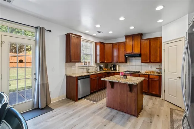 a view of a dining room with furniture and a flat screen tv