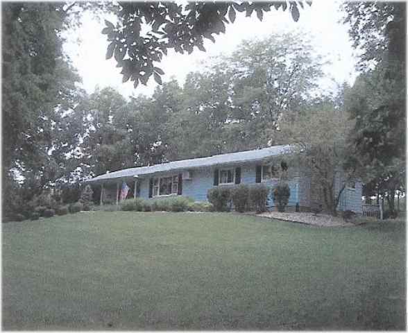 4590 Big Hill Road Chadwick, IL 61014 - Photo 1 of 4 a front view of a house with a garden and trees