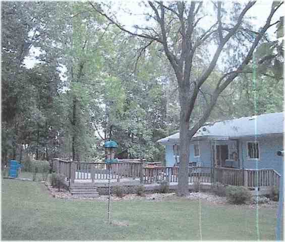 4590 Big Hill Road Chadwick, IL 61014 - Photo 3 of 4 a view of a house with a yard and a tree