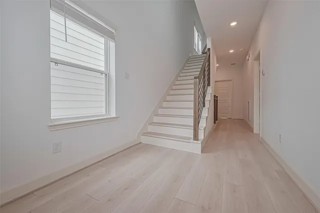 a view of entryway and hall with wooden floor