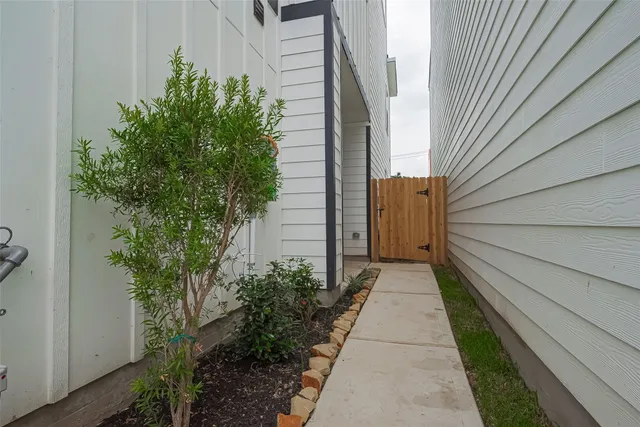 a pathway of a house with backyard