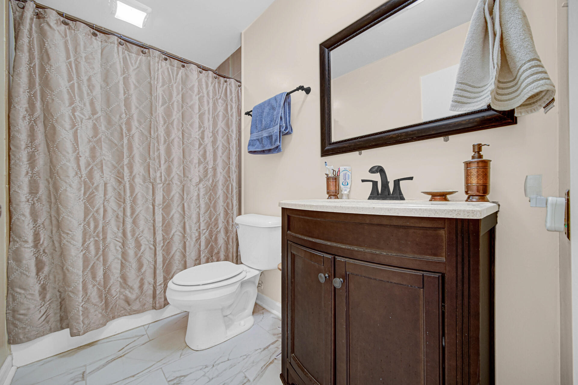 7933 Jefferson Avenue, Unit 4B Munster, IN 46321 - Photo 15 of 20 a bathroom with a sink a toilet and a mirror