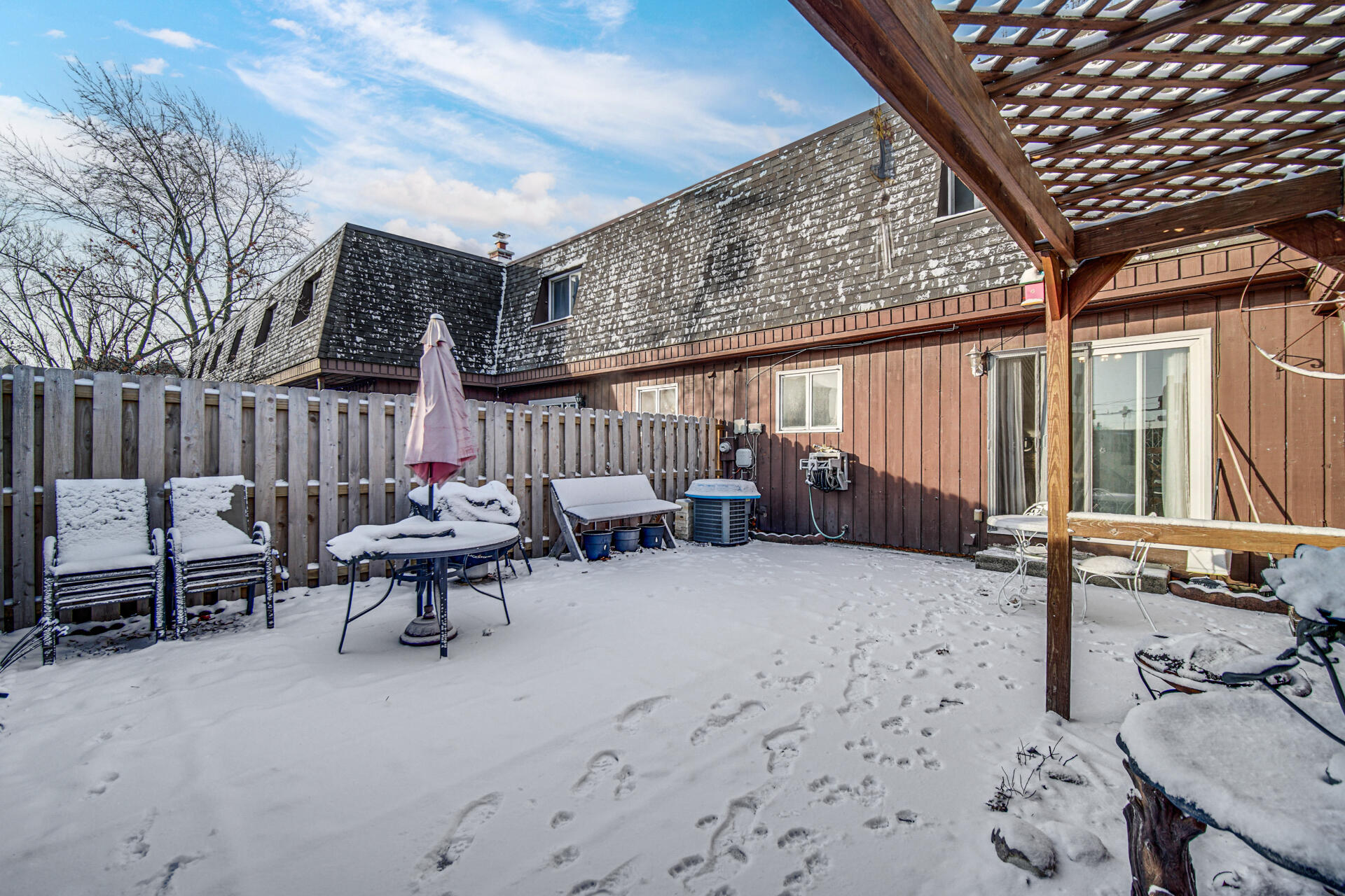 7933 Jefferson Avenue, Unit 4B Munster, IN 46321 - Photo 20 of 20 a roof deck with table and chairs and wooden fence