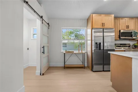 a view of kitchen with furniture and refrigerator