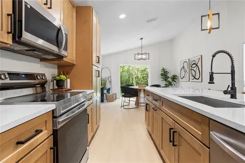 a kitchen with stainless steel appliances a sink microwave and stove