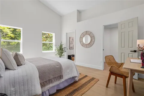 a bedroom with a bed and a chair