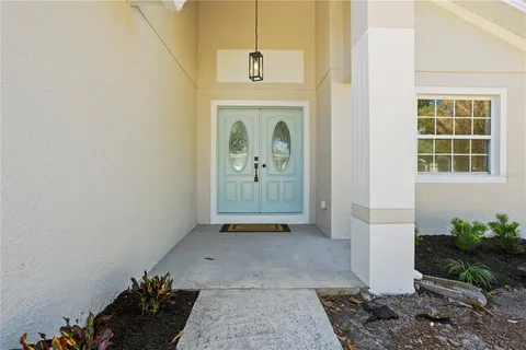 a view of a hallway with entryway door