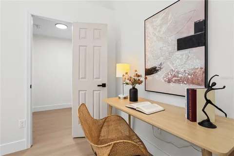 a dining room with furniture and wooden floor