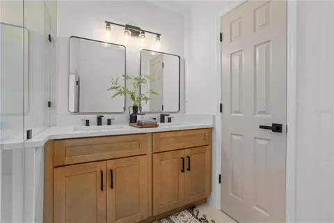 a bathroom with a double vanity sink and mirror