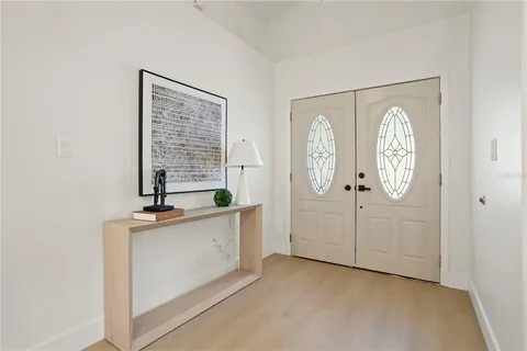 a view of a kitchen with fridge and window