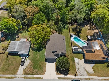 an aerial view of a house with a yard