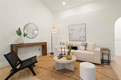 a living room with furniture a table and a potted plant