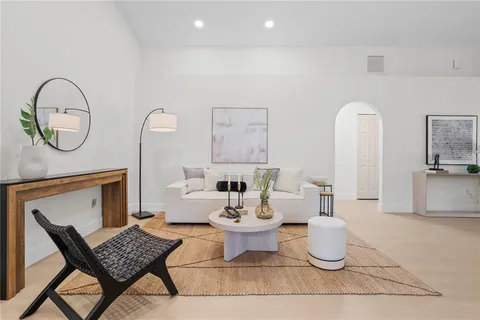 a living room with furniture a table and window