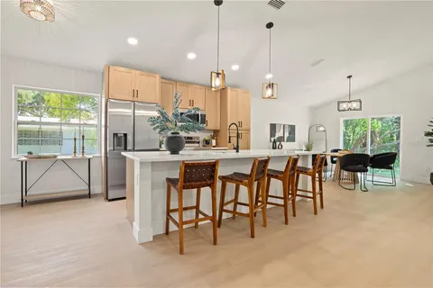 a large kitchen with a table and chairs